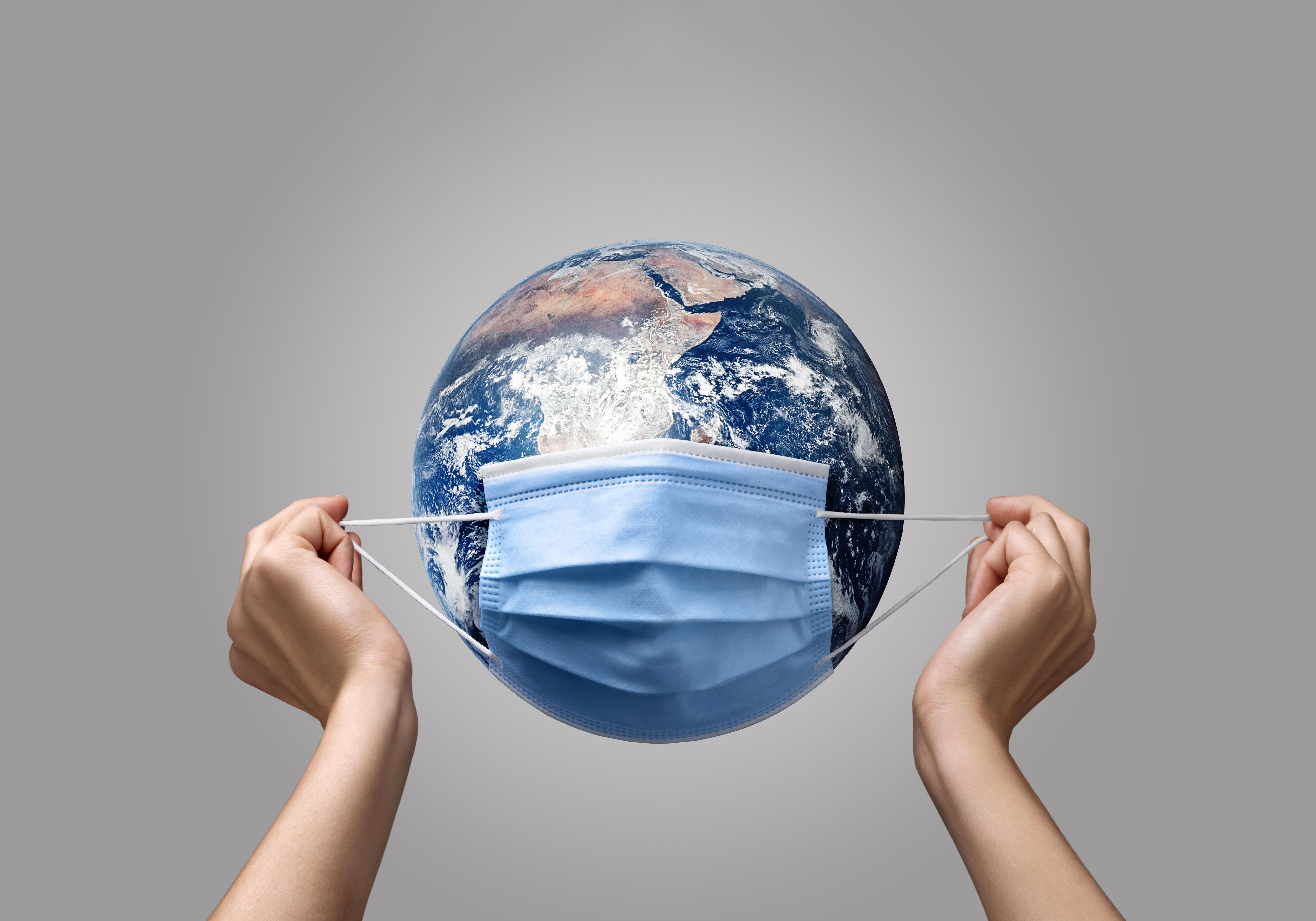 person-putting-medical-mask-earth
